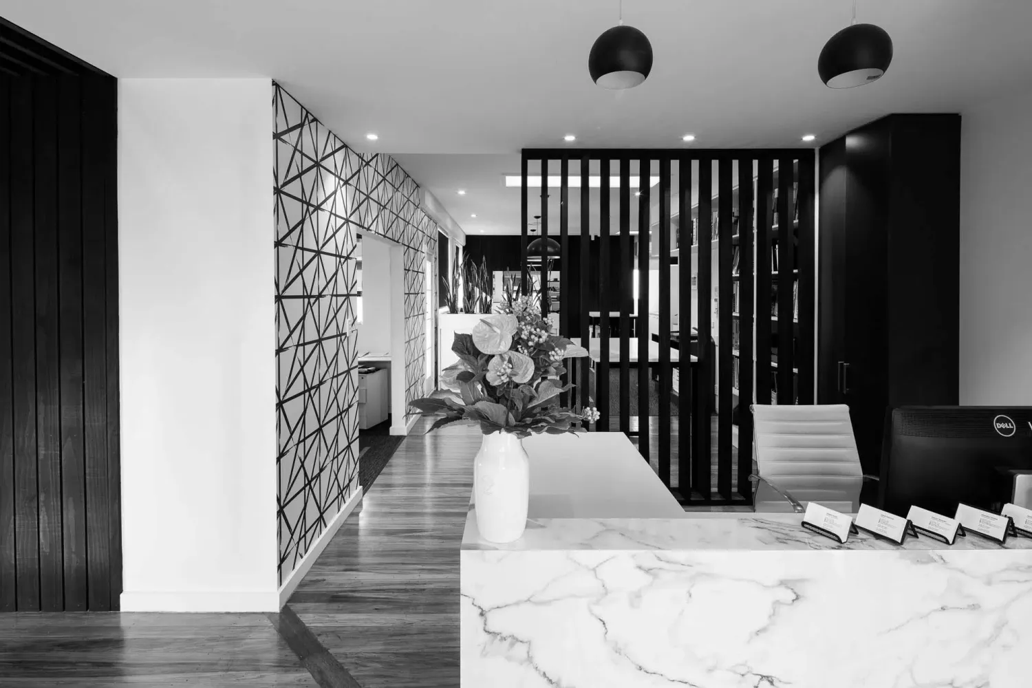 Reception at the Chilton + Mayne architectural design studio, Christchurch, with marble counter and geometric feature wall